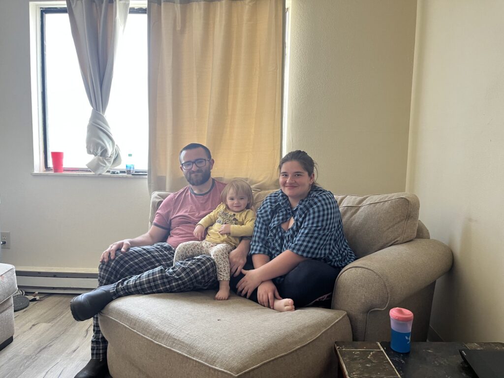 Family on couch smiling