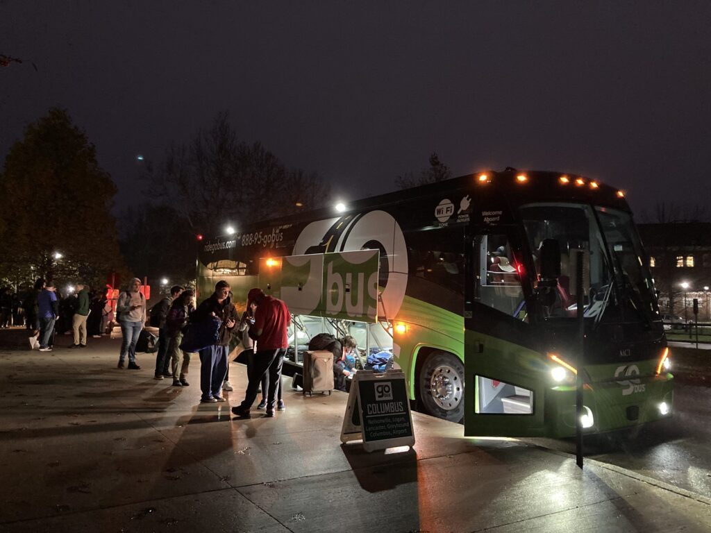 A photo of riders getting onto the GoBus at night.