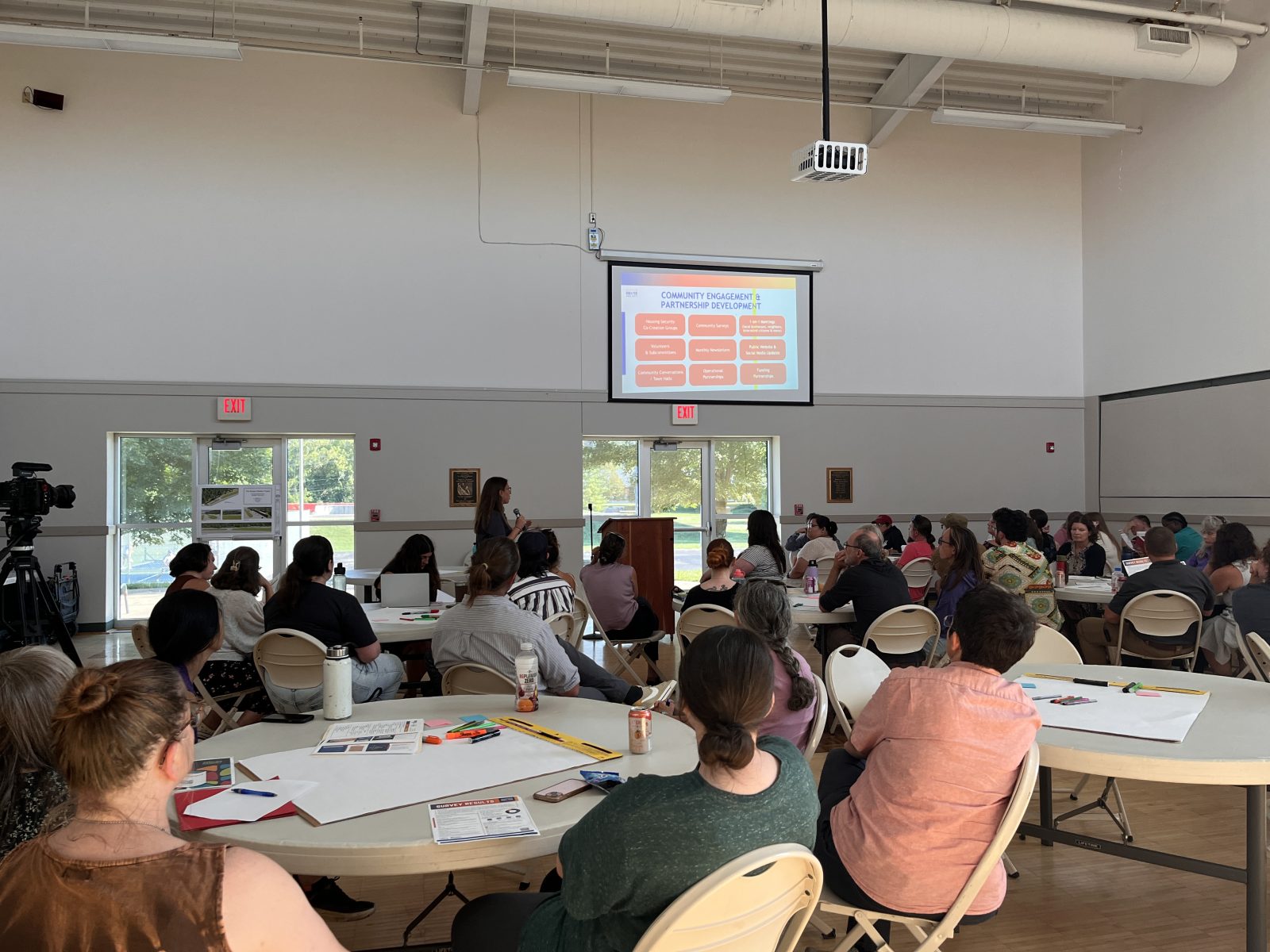 people gather at the community center to discuss the Sunset Shelter Project and view a presentation
