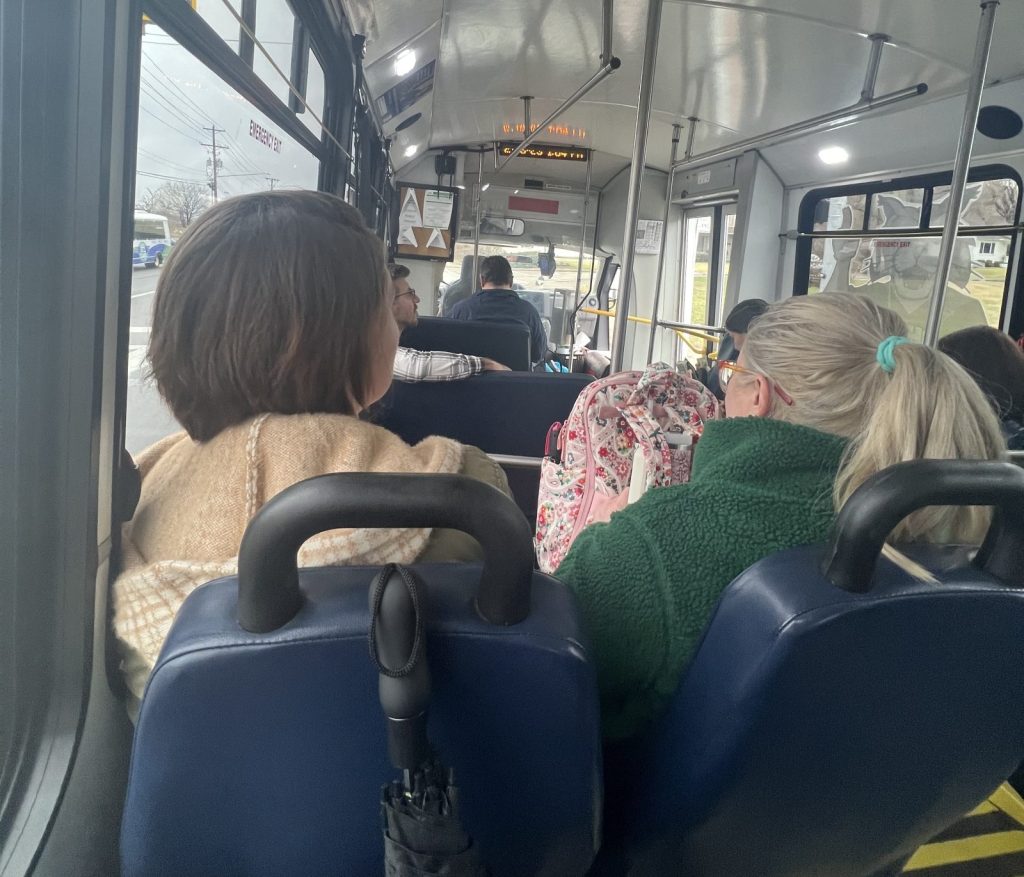 photo of two women sitting on an APT bus taken from the seat behind.