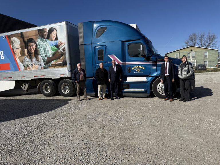 photo of church representatives standing with the semi truck of donated food