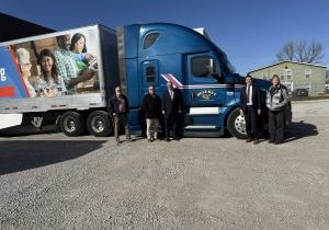 photo of church representatives standing with the semi truck of donated food
