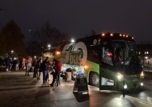 A photo of riders getting onto the GoBus at night.