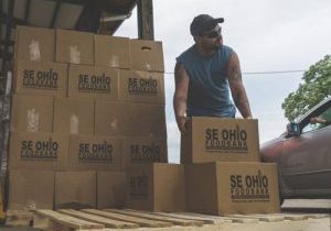 Man carrying foodbank boxes at warehouse
